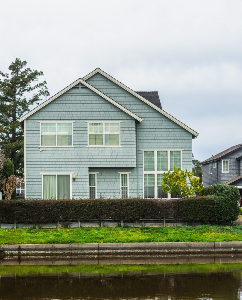A contemporary detached house in a suburban neighborhood with a scenic canal front.